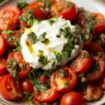 Burrata salad with heirloom tomatoes and basil on plate
