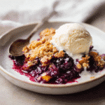 Blueberry nectarine crisp served warm with vanilla ice cream