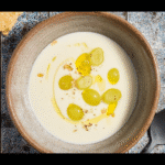 Ajo blanco soup served in a ceramic bowl