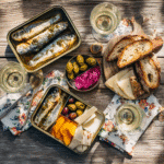 Bright tin fish date night setup with seafood, bread,
