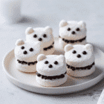 Ghostly Marshmallow Sandwich Cookies close-up on white plate