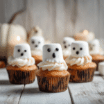 Spooky Ghost Cupcakes with Marshmallow Toppers on Wooden Table