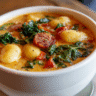 Spicy Sausage Gnocchi Soup with Kale in a white bowl