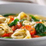 Healthy Chicken Tortellini Soup in a white bowl