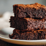 Whole Wheat Eggless Brownies stacked on white plate