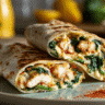 Cheesy Garlic Chicken Wraps with Spinach on a white plate