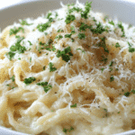 Potato Noodles in Creamy Alfredo Sauce served in a white bowl