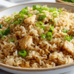 Speedy Chicken Fried Rice Recipe in bright white bowl with green onion garnish