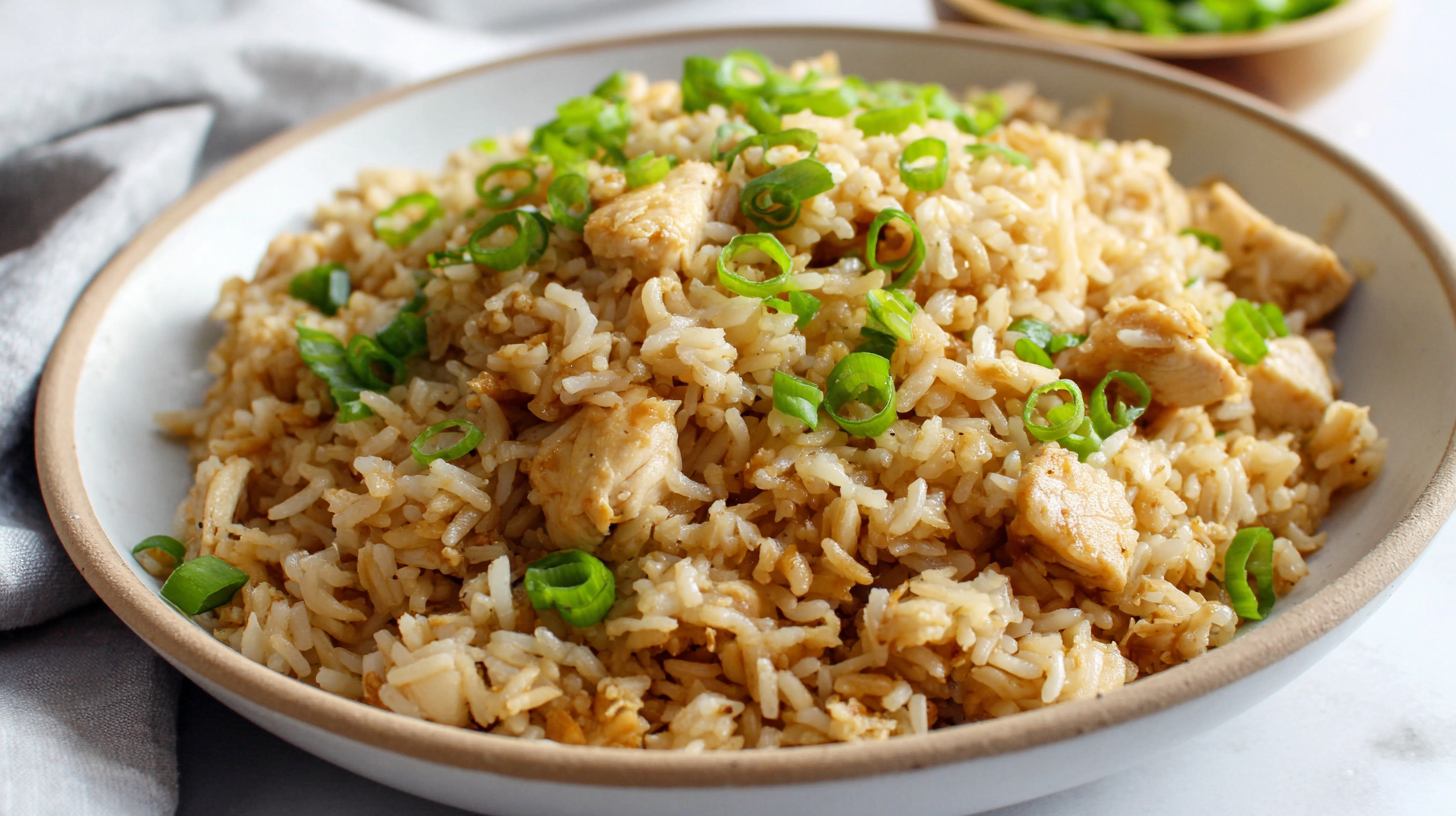 Speedy Chicken Fried Rice Recipe in bright white bowl with green onion garnish