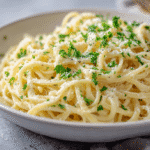 Creamy Garlic Potato Noodles served in a white bowl