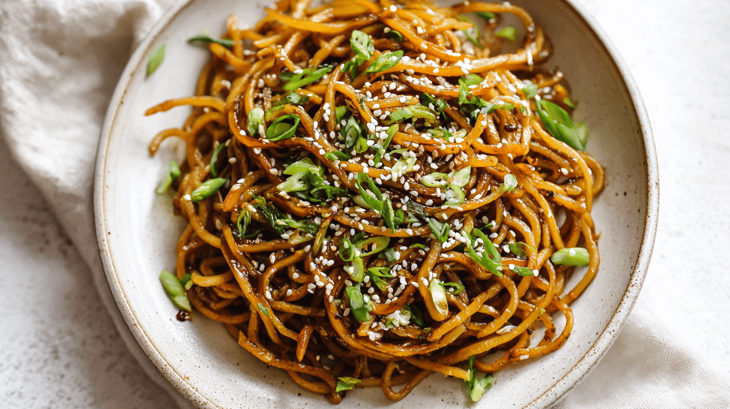 Pan-Fried Potato Noodles with Soy Garlic Sauce served on a white plate