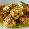 Garlic Butter Chicken Bites on white plate with parsley garnish