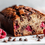 Raspberry Dark Chocolate Banana Bread sliced on white marble