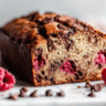 Raspberry Dark Chocolate Banana Bread sliced on white marble