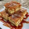 Delicious caramel apple cheesecake bars topped with caramel drizzle