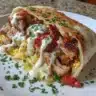 Chicken Shawarma drizzled with creamy garlic sauce on a platter