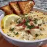 Bowl of cozy Greek Lemon Chicken Soup garnished with fresh herbs