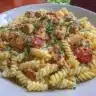 Creamy Cajun chicken pasta served in a bowl with fresh herbs and spices