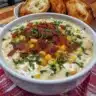 Bowl of creamy Crockpot Chicken Corn Chowder with corn and herbs