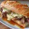 Delicious Crockpot French dip sandwiches with tender meat and dipping sauce.