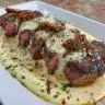 Delicious Garlic Butter Steak topped with rich Parmesan cream sauce