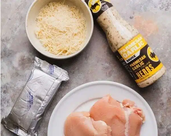 Delicious Garlic Parmesan Chicken Pasta served with fresh herbs and grated cheese