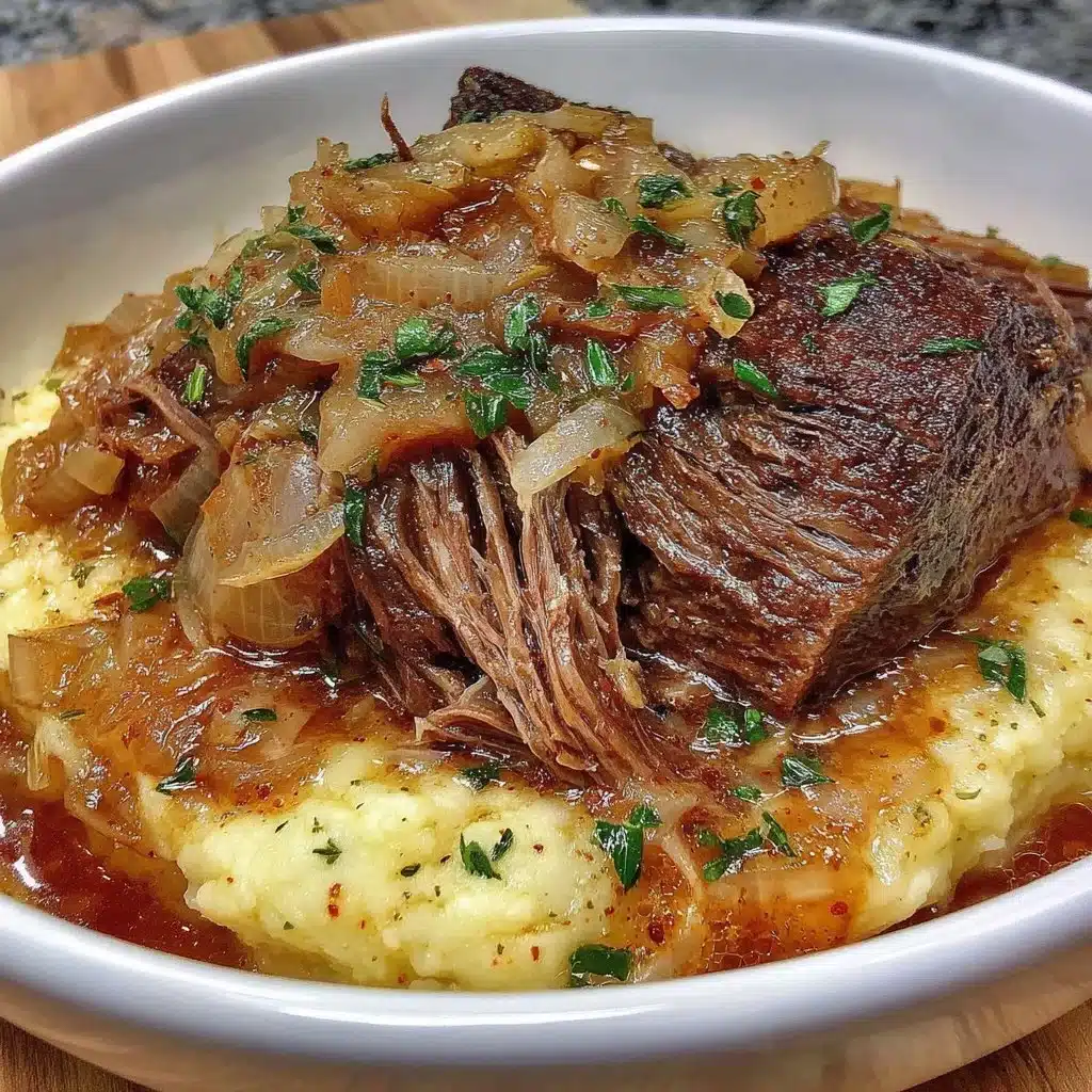 Juicy French Onion Pot Roast served with caramelized onions on a plate.