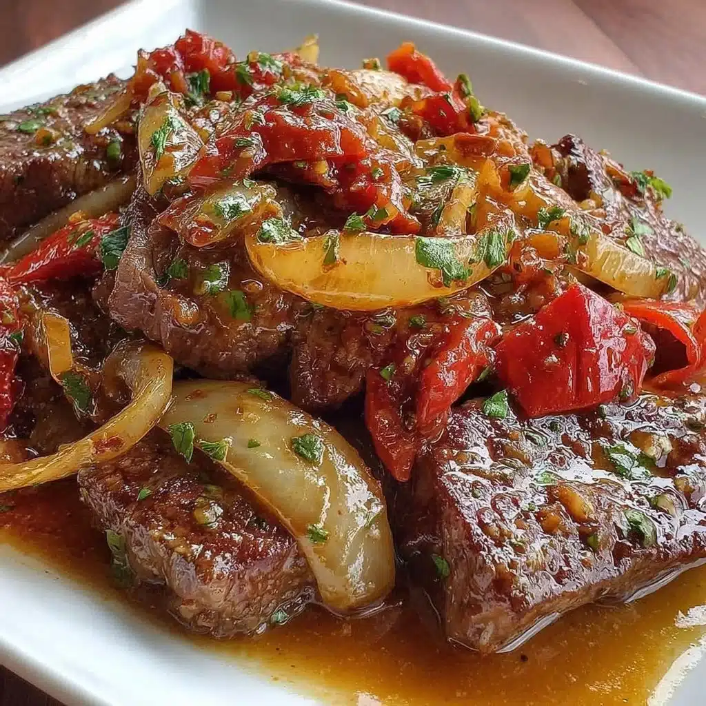 Sizzling Chinese pepper steak with onions served on a plate.