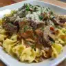 Creamy slow cooker beef stroganoff served over egg noodles