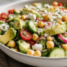 Chickpea Feta Avocado Dinner Salad in white bowl with fresh herbs