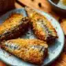 Crispy air fryer canned sardines patties on a plate garnished with herbs