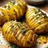 Air Fryer Garlic Butter Hasselback Potatoes served with fresh herbs
