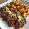 Air Fryer garlic butter steak with potato foil packets ready to serve.