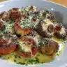 Delicious air fryer garlic mushrooms on a plate garnished with herbs.