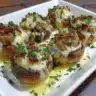 Air Fryer Sausage Stuffed Mushrooms topped with herbs and cheese