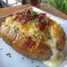 Delicious airfryer loaded baked potato topped with cheese and chives