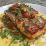 Baked cilantro lime salmon garnished with fresh herbs