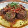 Plate of braised beef with Mediterranean spices garnished with herbs