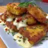 Golden cheesy fritters served on a plate with dipping sauce