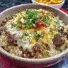 Cheesy Taco Rice Skillet dish with colorful ingredients in a pan