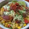 Chicken bowls with street corn and fresh veggies served in a vibrant dish.