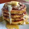 Deliciously stacked cinnamon roll pancakes with icing on top