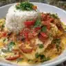 Coconut lime fish curry served with jasmine rice on a vibrant plate