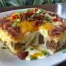 Delicious Cowboy Casserole served in a rustic dish with cheese and toppings
