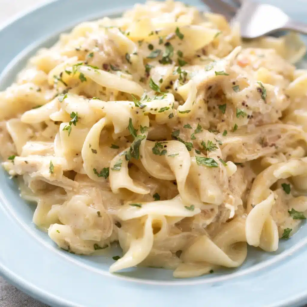 Delicious Crockpot Chicken and Noodles with creamy sauce and egg noodles in a bowl.