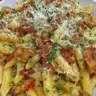 Delicious Crack Chicken Penne Pasta served in a bowl with herbs on top