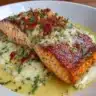 Creamy garlic salmon dish garnished with herbs and served on a plate