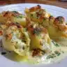 Delicious creamy seafood stuffed shells topped with cheese and herbs