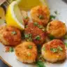 Delicious air fryer scallops served on a plate with garnish.