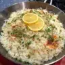 Delicious Greek Lemon Rice served in a bowl garnished with herbs